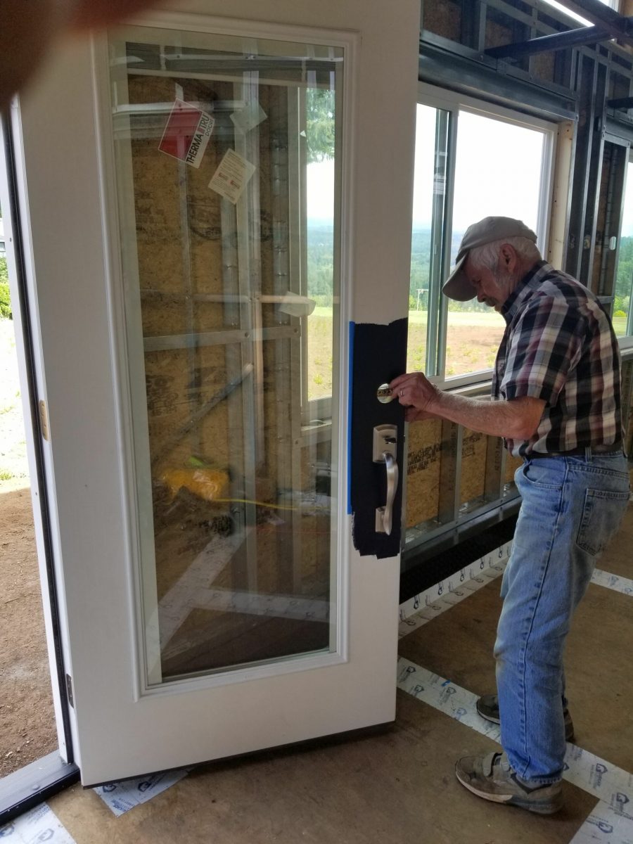Dad installing door hardware
